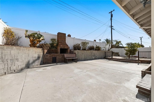 view of patio / terrace with an outdoor brick fireplace