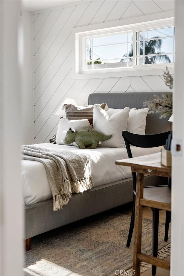 bedroom with wood walls