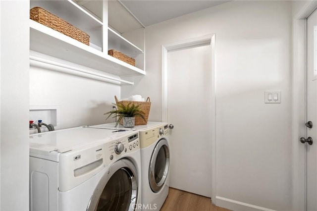 washroom featuring light hardwood / wood-style flooring and independent washer and dryer