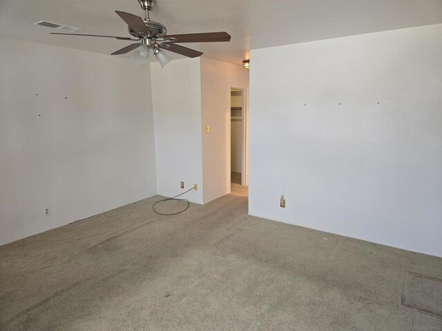 unfurnished room featuring ceiling fan and carpet floors