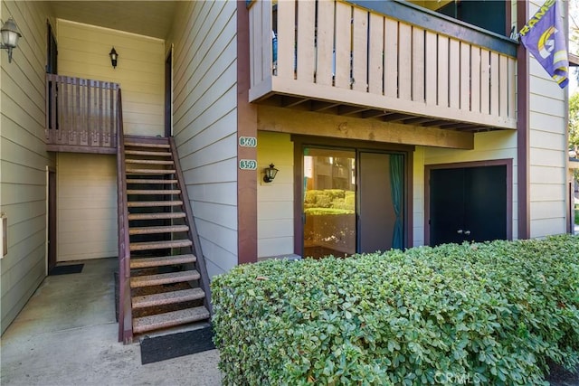 view of exterior entry with a balcony