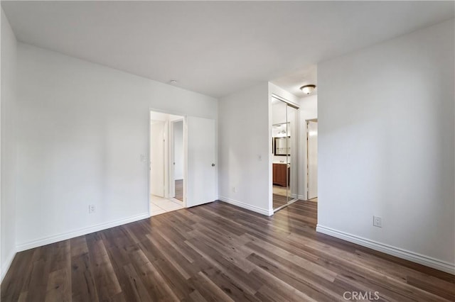 spare room with dark hardwood / wood-style flooring