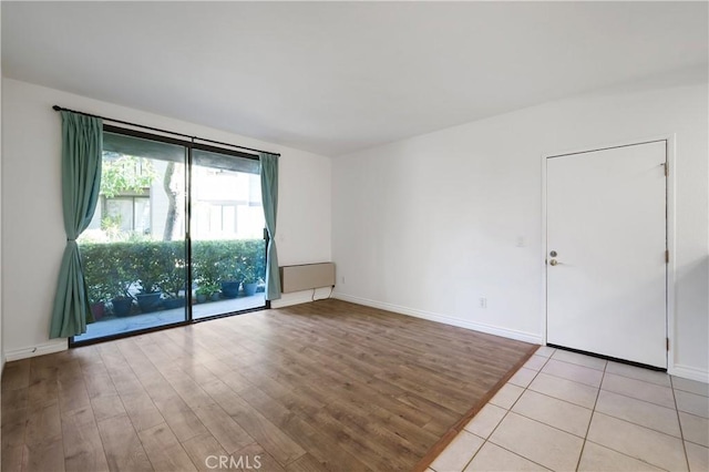 spare room with light hardwood / wood-style flooring