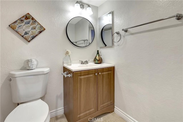 bathroom with tile patterned floors, vanity, and toilet