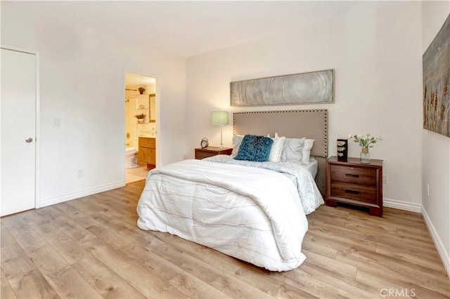 20702 El Toro Rd Unit 359, Lake Forest, CA 92630 - bedroom featuring connected bathroom, baseboards, and wood finished floors