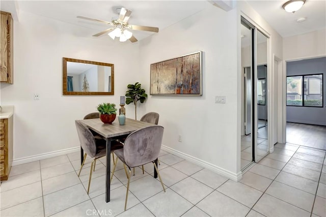 dining area with light tile patterned floors and ceiling fan