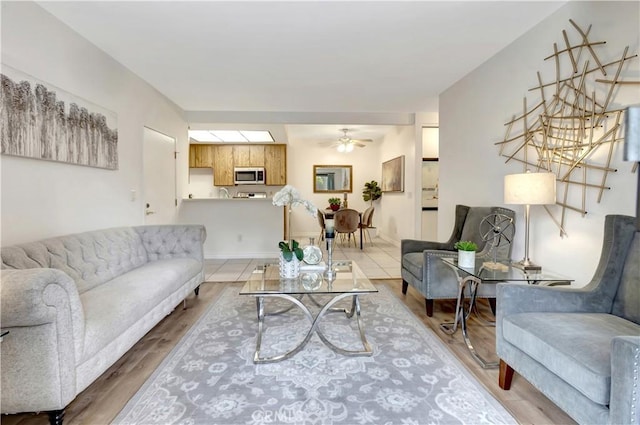 living room featuring wood-type flooring and ceiling fan