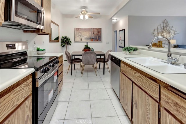 kitchen with sink, light tile patterned floors, ceiling fan, and appliances with stainless steel finishes