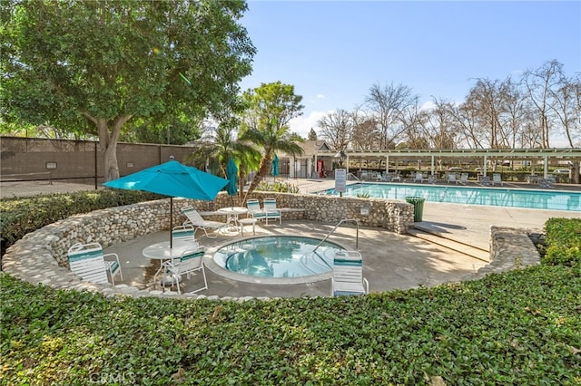 view of pool featuring a hot tub and a patio