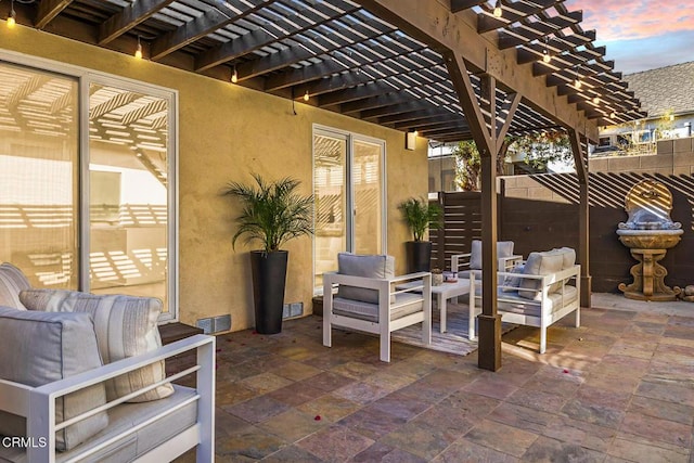 patio terrace at dusk with an outdoor hangout area and a pergola