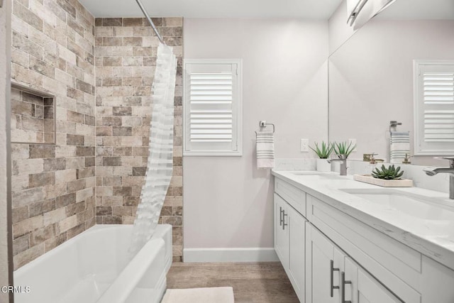 bathroom featuring a healthy amount of sunlight, vanity, and shower / bath combo