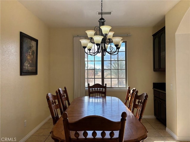 tiled dining space featuring a notable chandelier