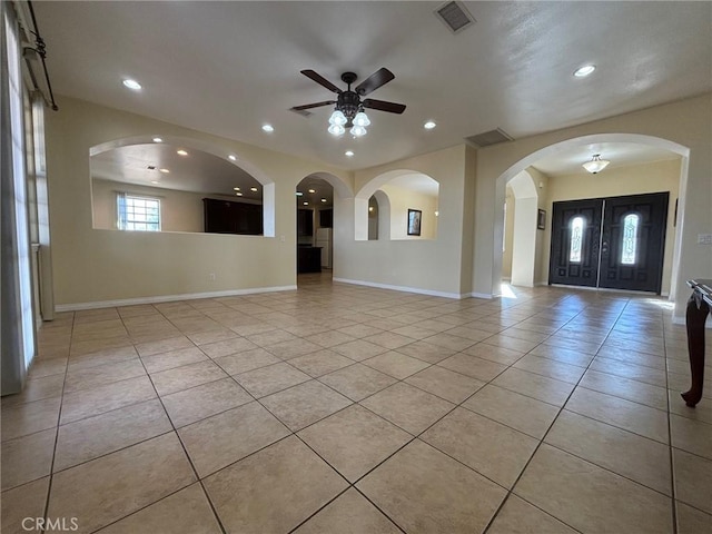 interior space with ceiling fan