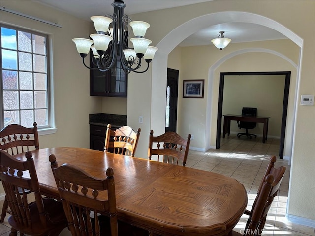 tiled dining area featuring a notable chandelier