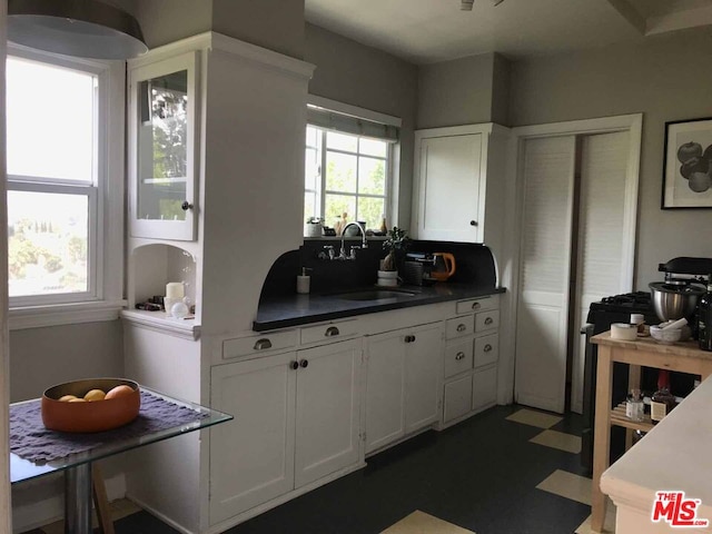 kitchen with sink and white cabinetry