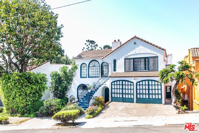 mediterranean / spanish home with a garage