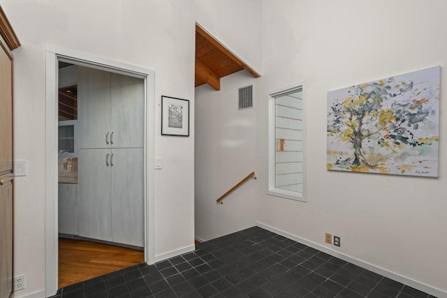 stairs featuring wooden ceiling and vaulted ceiling with beams