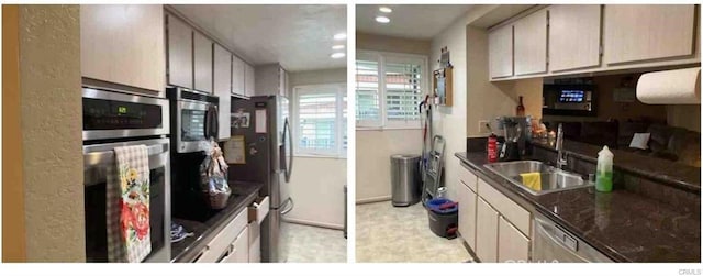 kitchen with light brown cabinetry, sink, stainless steel appliances, and dark stone countertops