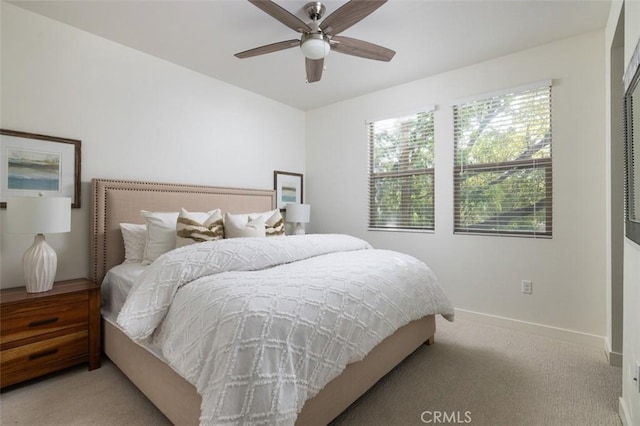 bedroom featuring ceiling fan and light colored carpet