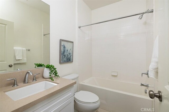 full bathroom with toilet, tiled shower / bath, and vanity