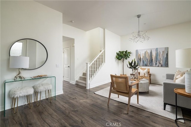 living room with dark hardwood / wood-style floors and an inviting chandelier