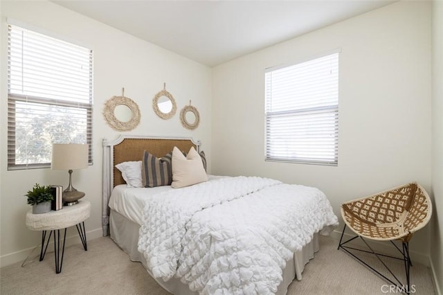 carpeted bedroom with multiple windows