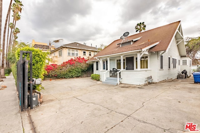 view of front of house with central AC unit and a porch