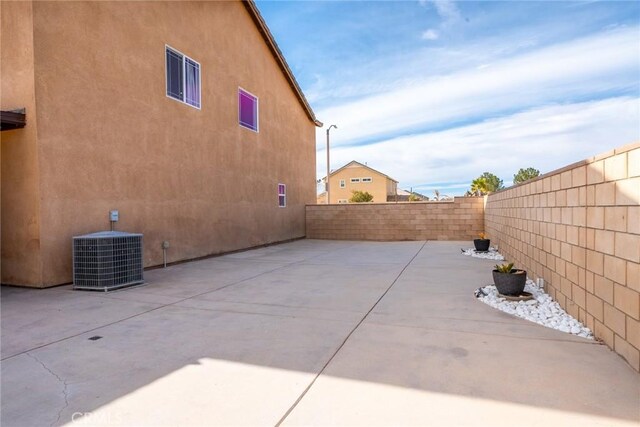 view of side of home with a patio area and cooling unit