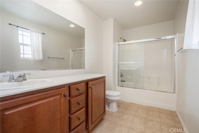 full bathroom with toilet, combined bath / shower with glass door, and vanity