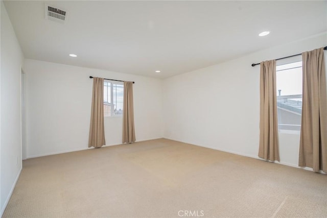 unfurnished room with light colored carpet