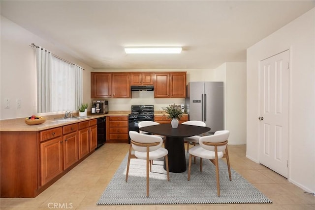 kitchen featuring light tile patterned flooring, sink, gas stove, and high end fridge