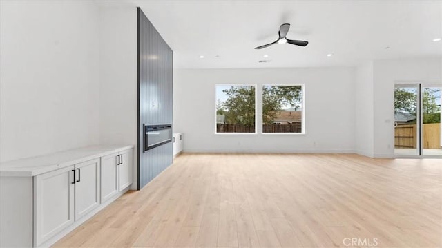 unfurnished living room with light hardwood / wood-style floors and ceiling fan