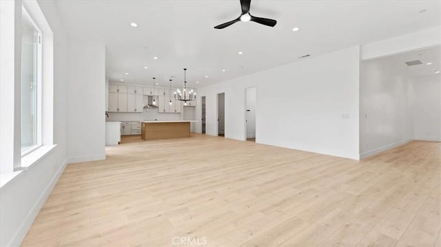 unfurnished living room with ceiling fan and light hardwood / wood-style floors