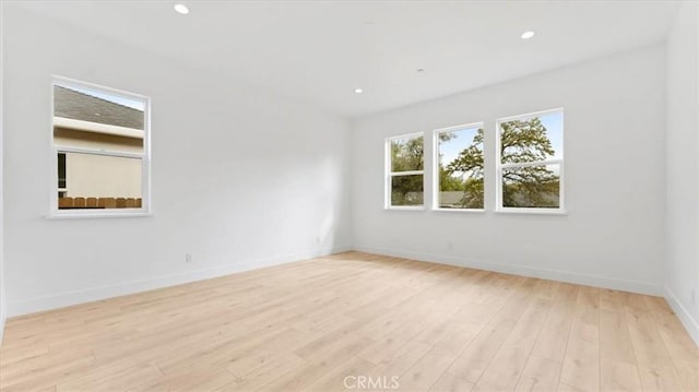 spare room featuring light hardwood / wood-style floors