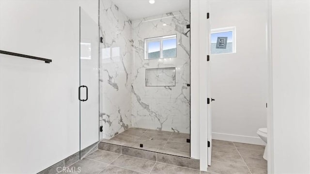 bathroom featuring toilet, tile patterned flooring, and a shower with shower door