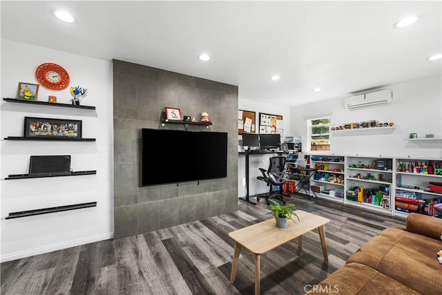 living room featuring hardwood / wood-style flooring and an AC wall unit