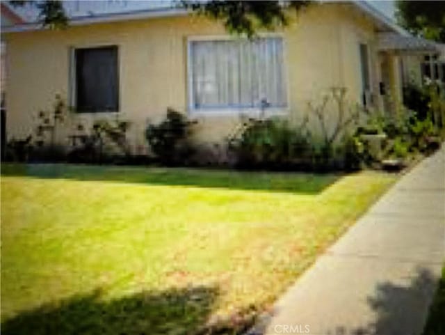 view of home's exterior with a lawn