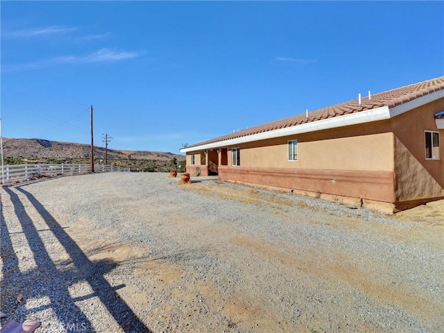 view of property exterior featuring a mountain view