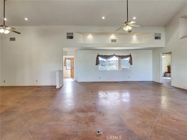 unfurnished living room with ceiling fan and a towering ceiling