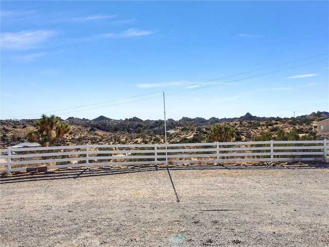 view of yard featuring a rural view and a mountain view