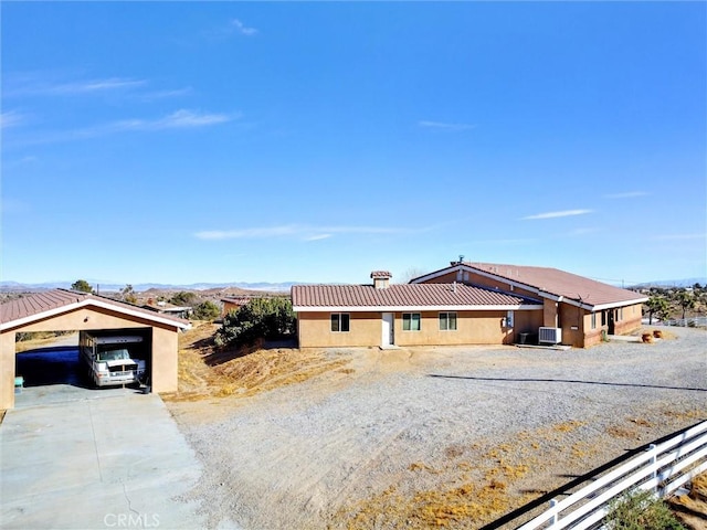 single story home featuring a carport and a mountain view