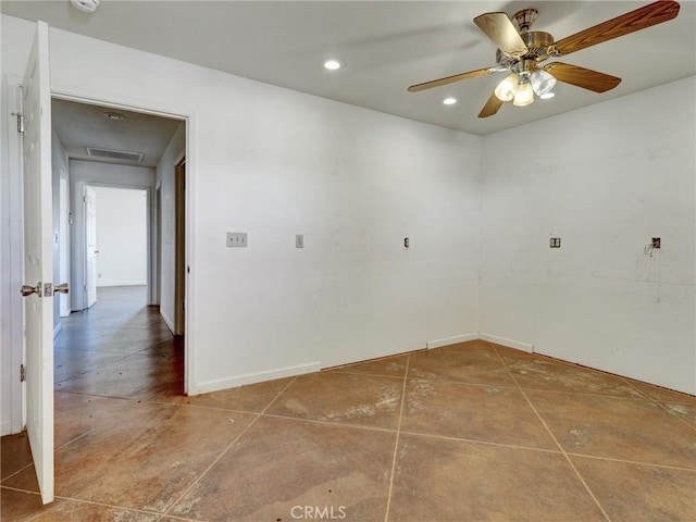 spare room with ceiling fan and tile patterned flooring