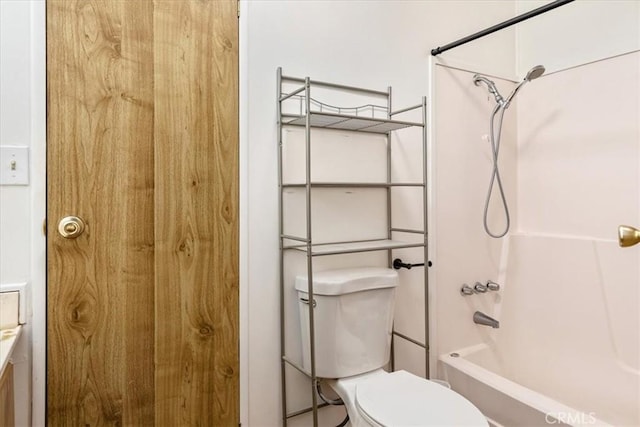 bathroom with shower / washtub combination and toilet