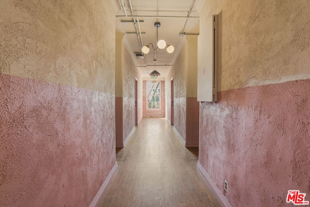 hall featuring crown molding and hardwood / wood-style floors