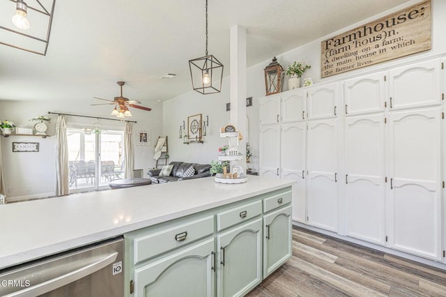 kitchen with decorative light fixtures, ceiling fan, light hardwood / wood-style floors, stainless steel dishwasher, and white cabinets