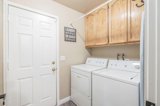 washroom featuring cabinets, hardwood / wood-style floors, and independent washer and dryer