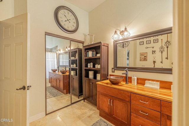 full bathroom featuring vanity and tile patterned flooring