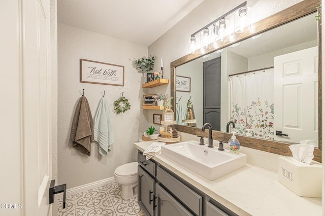 bathroom with baseboards, toilet, a shower with curtain, tile patterned floors, and vanity