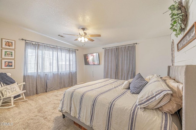 carpeted bedroom featuring visible vents, a textured ceiling, and ceiling fan