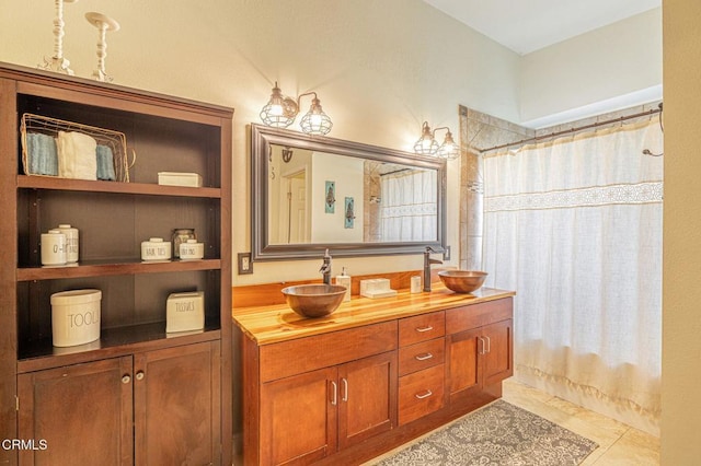 bathroom with double vanity, tile patterned flooring, a shower with shower curtain, and a sink